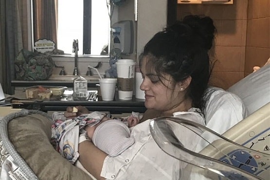 A picture of Joey's wife, Brittany holding their newly born baby.